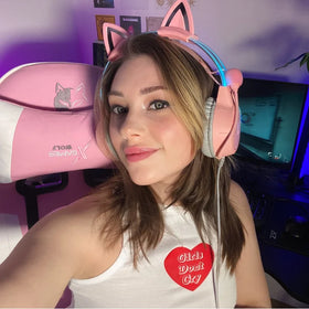 Trixie GamerGirlTrix posing in a gaming setup with a pink cat-ear headset