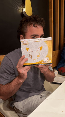 Collector holding Pokemon 30th Celebration Elite Trainer Box