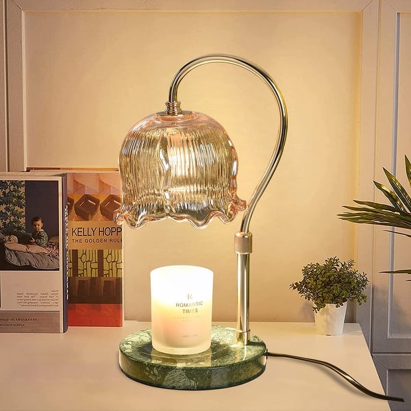 Decorative glass-shade candle warmer lamp on a marble-look base beside a candle. Illustrative reference for this article; exact model match not independently verified.