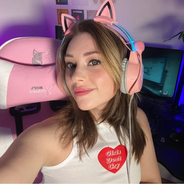 Trixie GamerGirlTrix posing in a gaming setup with a pink cat-ear headset