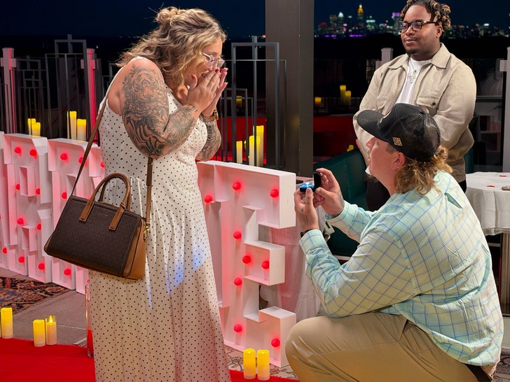 Lauryn Pumpkin Efird reacts during her rooftop engagement proposal to Darrin Kitchens; photo via TMZ