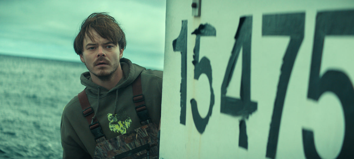 Charlie Heaton as Wade Penney beside a large boat number in Netflix's Below