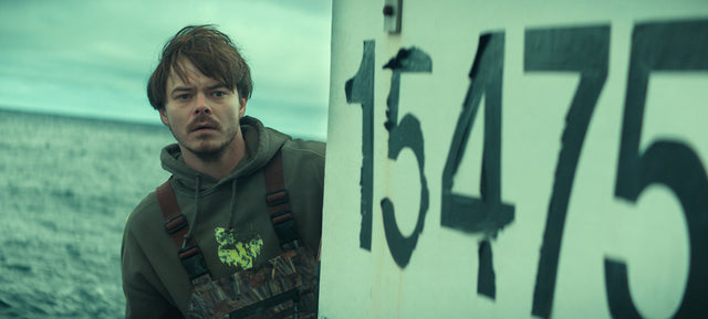Charlie Heaton as Wade Penney beside a large boat number in Netflix's Below