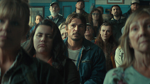 Josh Hartnett and residents of the fictional Newfoundland town in a community scene from Netflix's Below