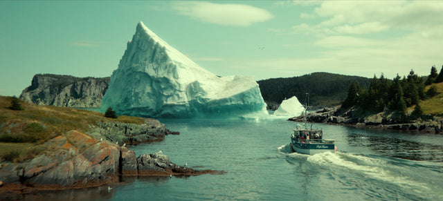 A fishing boat approaches a towering iceberg in Netflix's Below