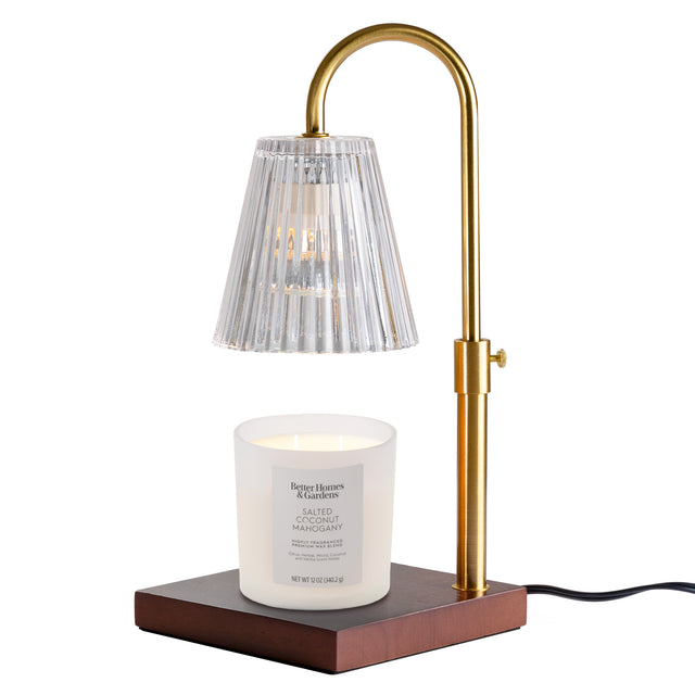 Adjustable brass candle warmer lamp with clear ribbed glass shade and dark wood base. Illustrative reference for this article; exact model match not independently verified.