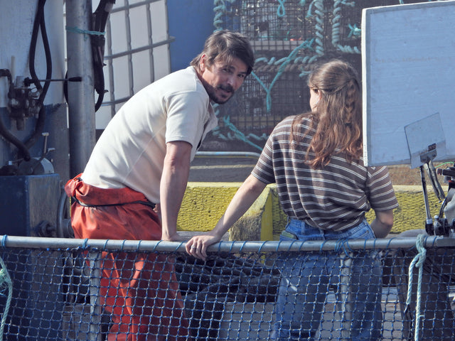 Josh Hartnett in orange fishing overalls on the set of Netflix's Below