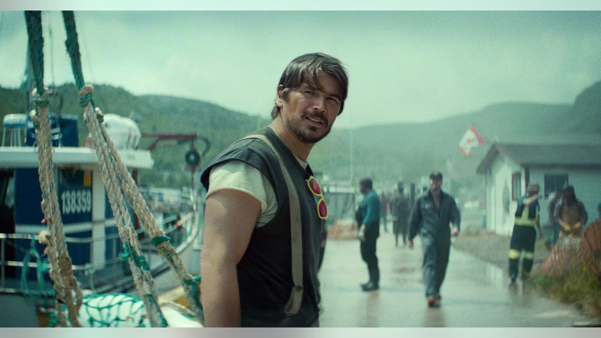 Josh Hartnett as Calvin Penney on a rain-darkened Newfoundland fishing dock in Netflix's Below