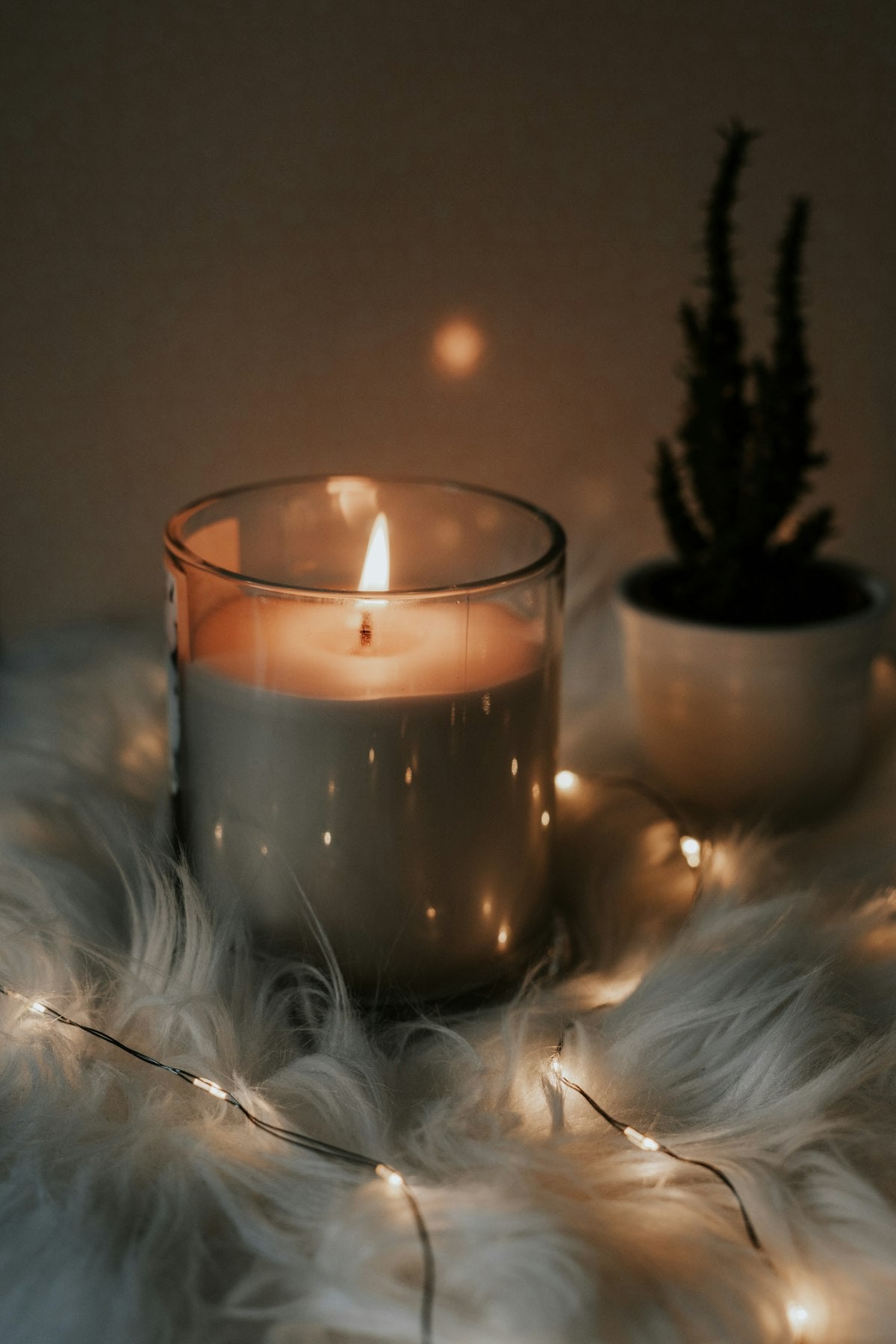 Decorative candle and warm ambient lighting illustrating the look of an electric candle warmer lamp. Illustrative reference for this article; exact model match not independently verified.