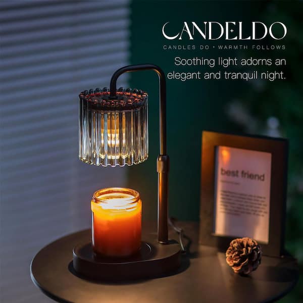 Brass and smoke-gray ribbed glass candle warmer lamp above a jar candle